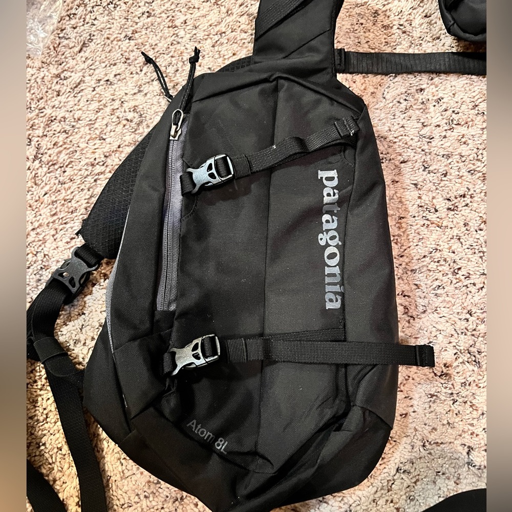 Black Patagonia Atom 8L sling bag.